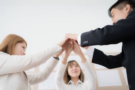 Business people group joining hands and representing concept of friendship and teamwork. Asian peopleの写真素材