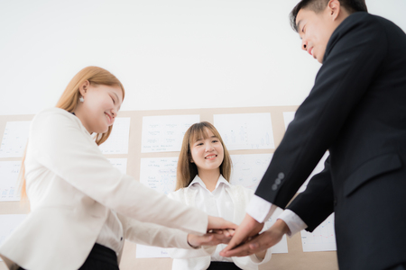 Business people group joining hands and representing concept of friendship and teamwork. Asian peopleの写真素材