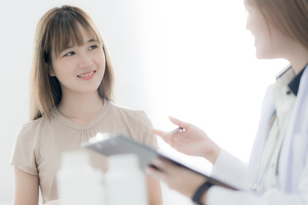 Doctor explaining diagnosis to her female patient. Asian peopleの写真素材