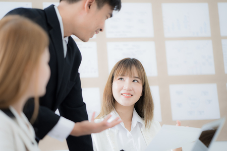Group of business people busy discussing documents and ideas at meetingの写真素材