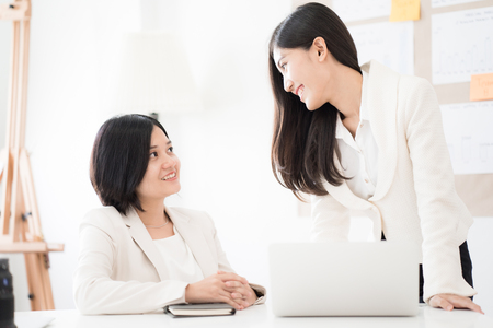 Two Businesswomen talking discussing concept in modern office. Asian peopleの写真素材