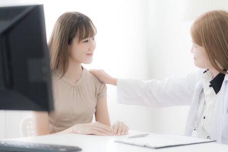 Doctor explaining diagnosis to her female patient. Asian peopleの写真素材