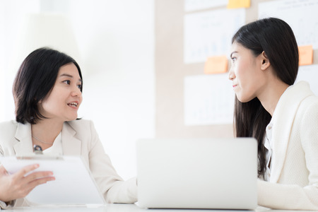 Two Businesswomen talking discussing concept in modern office. Asian peopleの写真素材