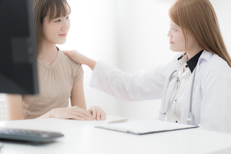 Doctor explaining diagnosis to her female patient. Asian peopleの写真素材