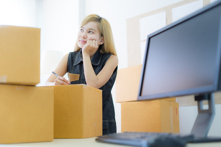 Young Asian woman working online shopping at home office