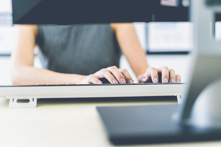 Business women reviewing data in financial charts and graphs in the officeの写真素材