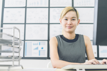 Business women reviewing data in financial charts and graphs in the officeの写真素材