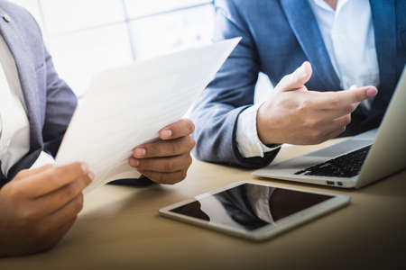 Business partners discussing documents and ideas at meetingの写真素材