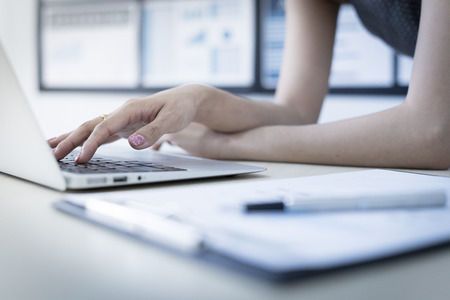 Business women reviewing data in financial charts and graphs