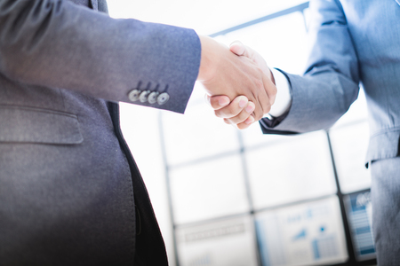 Businessman shaking hands to seal a deal with his partnerの写真素材