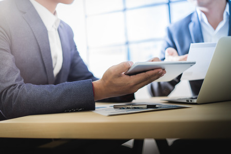 Business partners discussing documents and ideas at meetingの写真素材