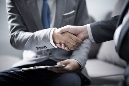 businessman shaking hands to seal a deal with his partnerの写真素材
