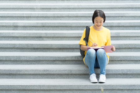 College asian student female sitting on staircaseの写真素材