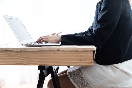 Business women reviewing data in financial charts and graphsの写真素材