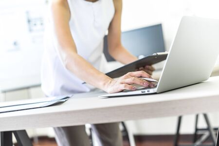 Business women reviewing data in financial charts and graphs. Accounting