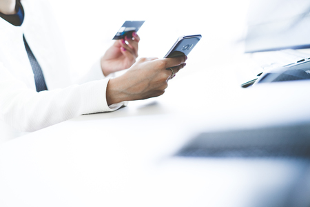 Woman Hands holding credit card and using mobile. Online shoppingの写真素材