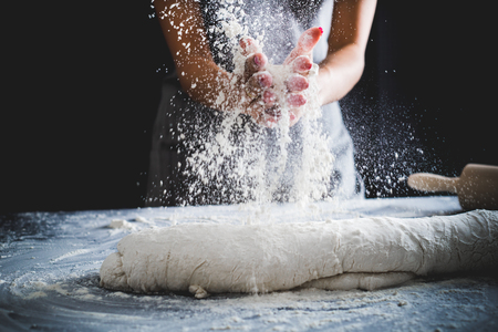 Making dough by female hands at bakeryの写真素材