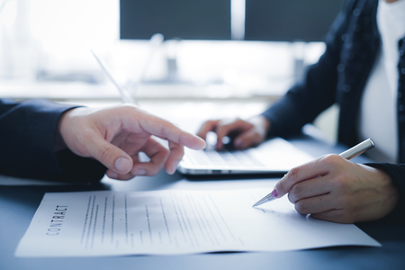 Female hand signing contract.の写真素材