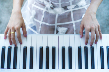 Young woman playing pianoの写真素材