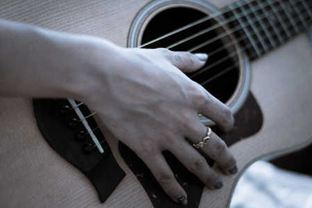 Young woman playing guitarの写真素材