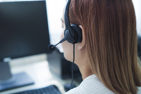 Asian young woman working in call centre