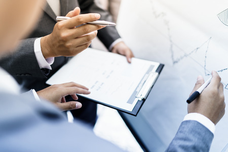 two young businessmen discussing project at meetingの写真素材