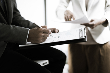 Business adviser analyzing financial figures denoting the progress in the work of the companyの写真素材