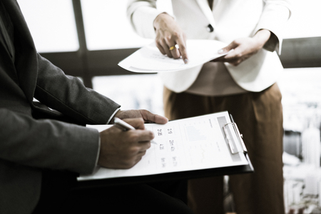 Business adviser analyzing financial figures denoting the progress in the work of the companyの写真素材