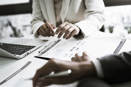 Business adviser analyzing financial figures denoting the progress in the work of the companyの写真素材