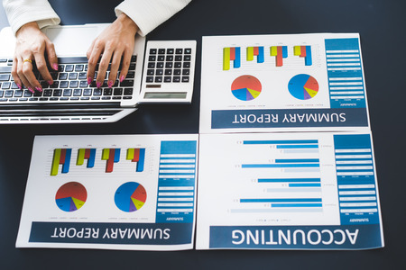 Business women reviewing data in financial statement. Accounting