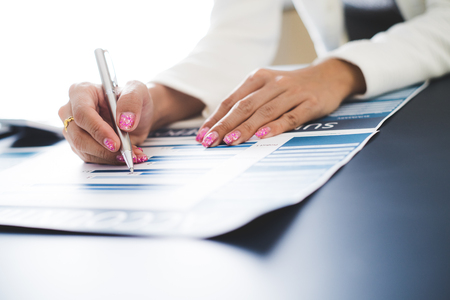 Business women reviewing data in financial statement. Accountingの写真素材