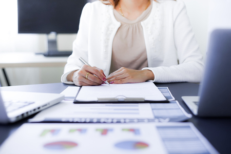 Female hand signing contract.の写真素材