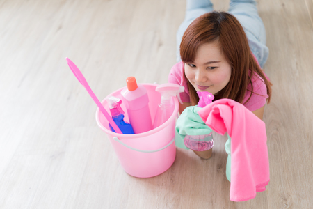 Cleaning concept. Asian woman with bucket of cleaning suppliesの写真素材