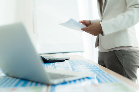 Business women reviewing data in financial charts and graphs. Accountingの写真素材