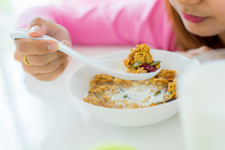 Asian woman Eating healthy breakfast bowlの写真素材
