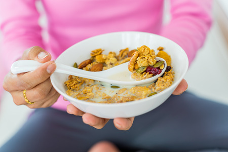 Asian woman Eating healthy breakfast bowl