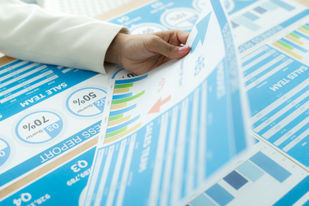 Business women reviewing data in financial charts and graphs. Accountingの写真素材