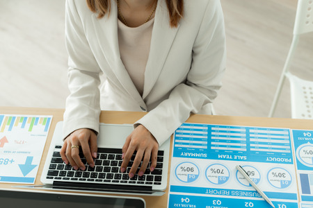 Business women reviewing data in financial charts and graphs. Accounting