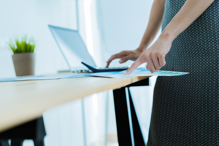 Business women reviewing data in financial charts and graphs. Accountingの写真素材