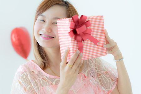 Asian woman holding gift boxの写真素材
