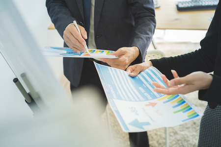 Business partners discussing documents and ideas at meetingの写真素材