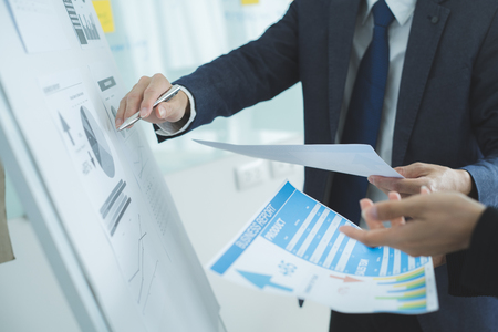 Business partners discussing documents and ideas at meetingの写真素材