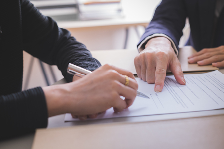 Female hand signing contract.の写真素材