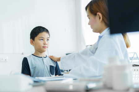 Asian little boy visiting a doctor. Medicine and children's therapy conceptの写真素材