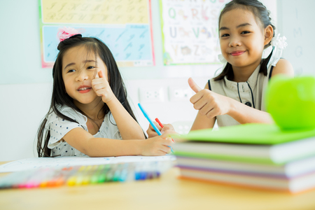 Asian cute little child girl drawing at home