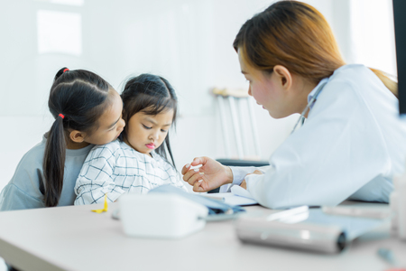 Asian cute girl visiting a doctor. Medicine and children's therapy conceptの写真素材