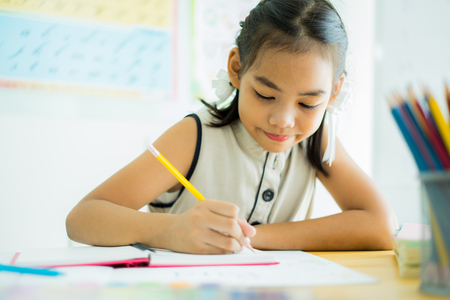 Asian cute little child girl drawing at homeの写真素材
