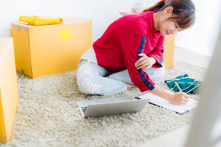 Asian young owner business woman working online shopping at home