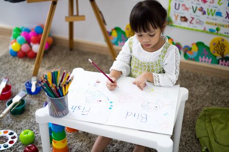 Asian cute little child girl drawing at home.の写真素材