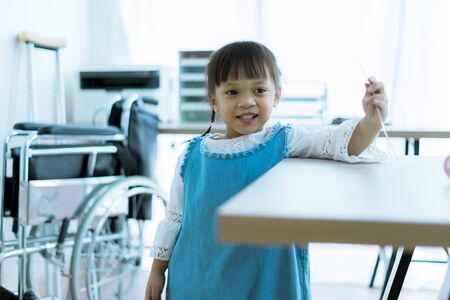 Asian little girl visiting a doctor. Medicine and children's therapy conceptの写真素材